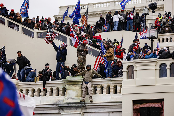 Capitol rioters on January 6 wave flags and support then President Donald Trump.