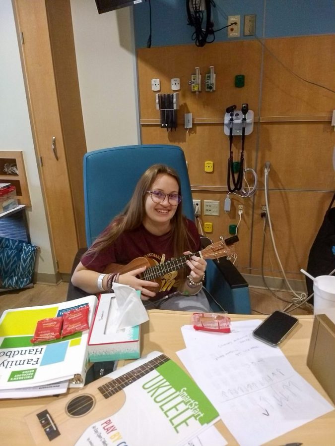 Allison Hale entertains herself with a ukulele while at the hospital. 