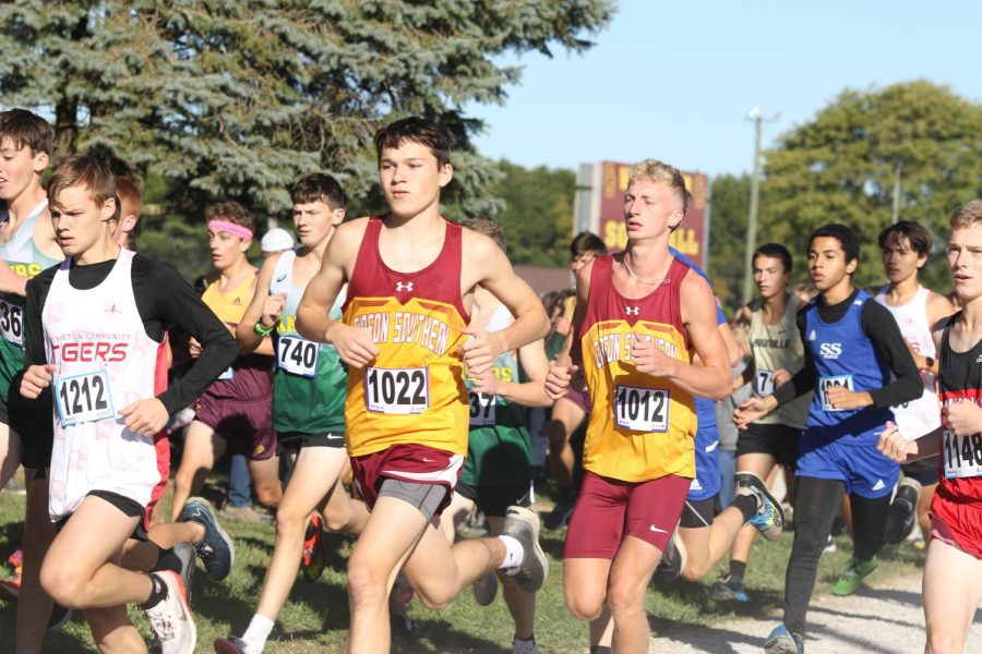 Juniors Lucian Wicker and Ethan Spindler blend into the pack at the start of the PAC meet.