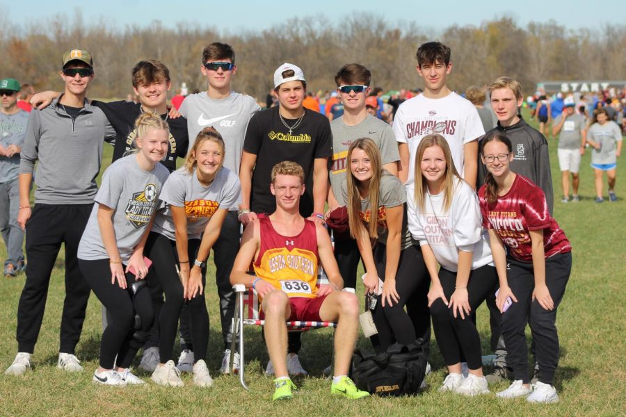 Spindler takes a well-deserved seat with his team of supporters at the State Meet on Saturday, October 29.