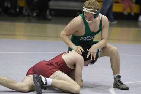 Freshman Kemper Pennington tries to keep control of his opponent at the Evansville Central wrestling Sectional.