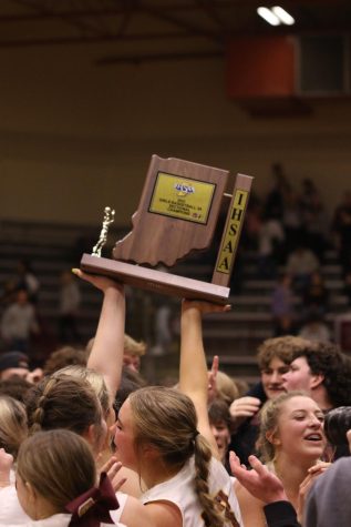 Seniors Alexis Tucker and Ava Weisheit hoist their Sectional trophy for all to see after beating the Memorial Lady Tigers 55-49.