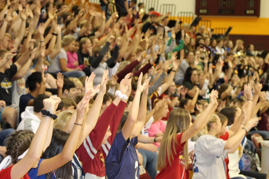 The entire student body throws their hands into the air for a roller coaster ride during the last pep rally on September 19, 2019, to celebrate the Fall Homecoming.