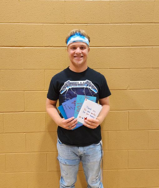 Senior Luke Snyder shows off some of the cards created for veterans on Honor Flights of Southern Indiana.