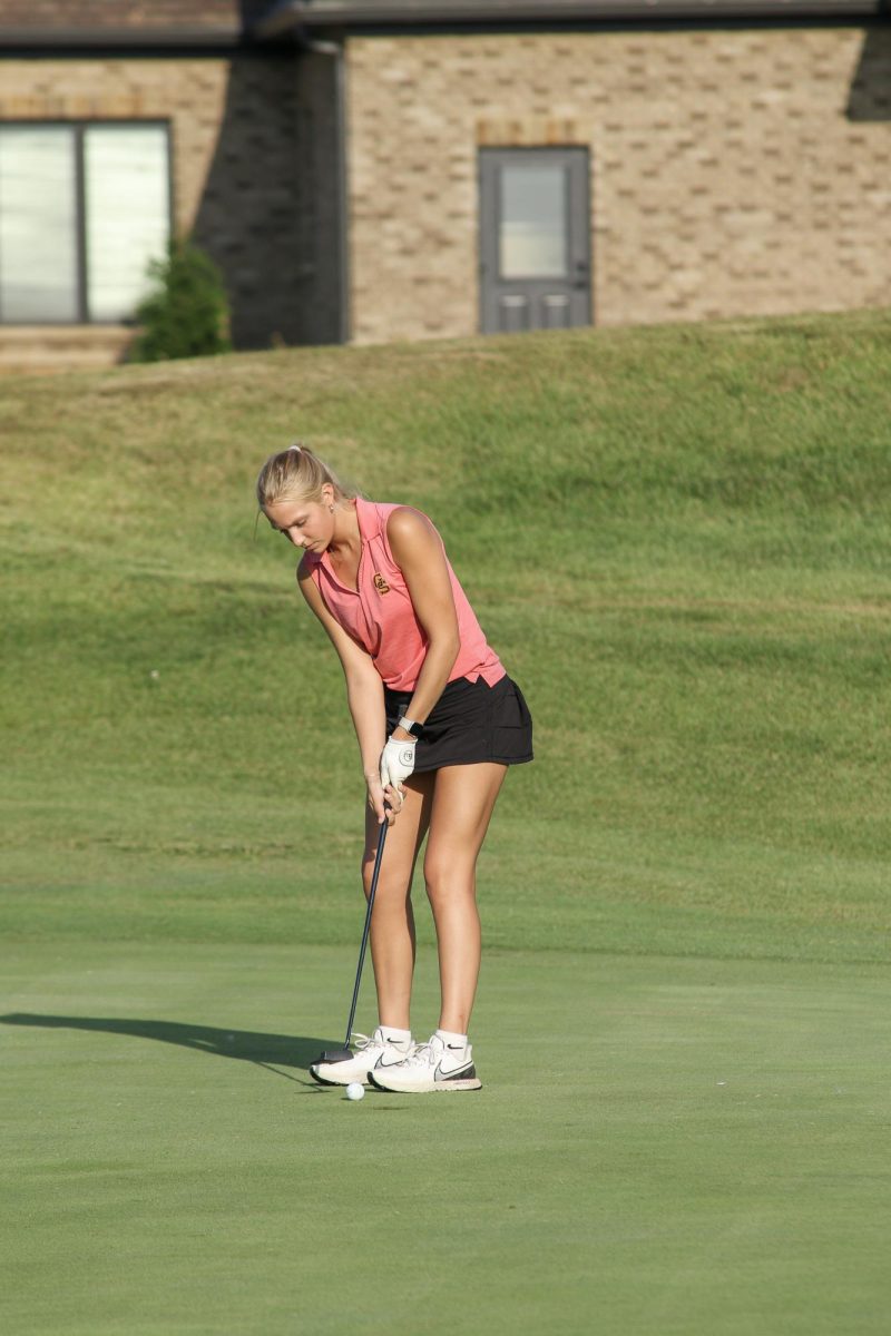 Senior Mallory Maurer follows though with her putt earlier in the season when the Lady Titans hosted Mater Dei at Cambridge Golf Course.