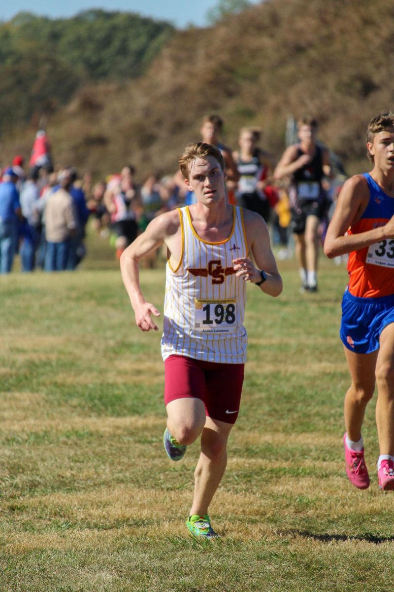 Senior Aiden Loveless pushes himself to cross the finish line during the last cross country race of his high school career. Loveless and the rest of his team were familiar with the Angel Mounds course because it was the same one they ran for the Sectional.