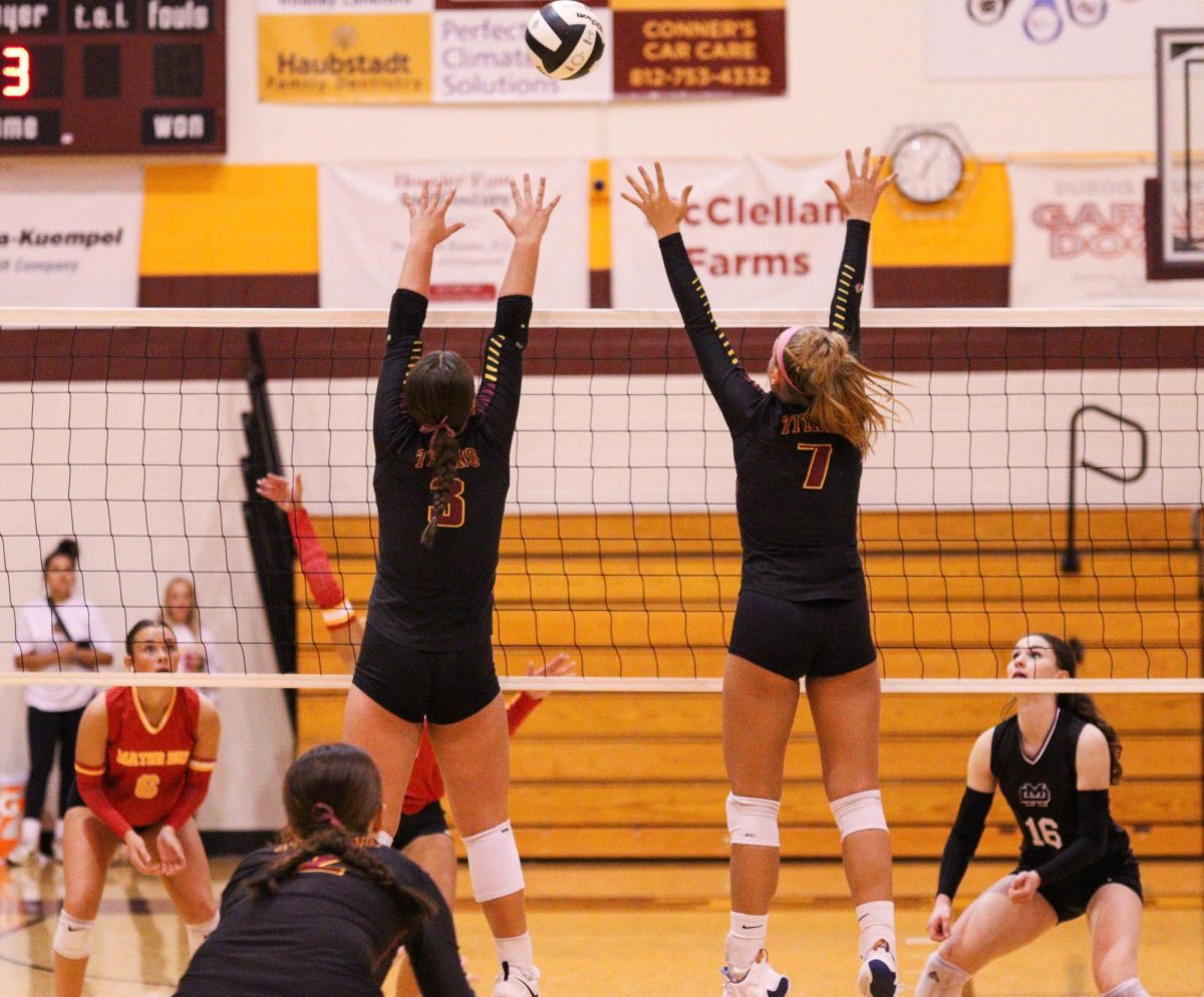 Junior Lauryn Adamson and senior Abby Deal go up for a block against Mater Dei in the volleyball Sectional.