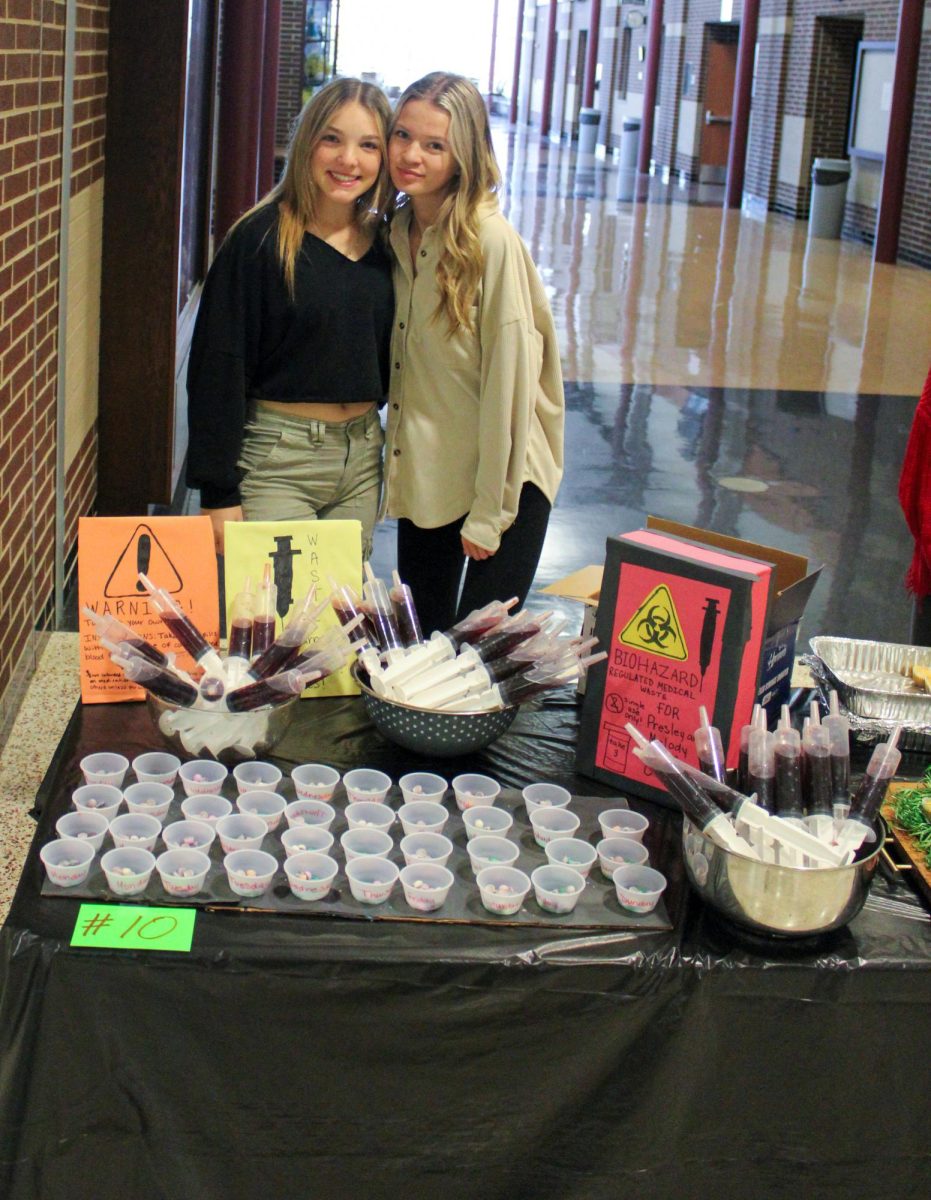 Melody Diephuis and Presley Auxier in front of their presentation.