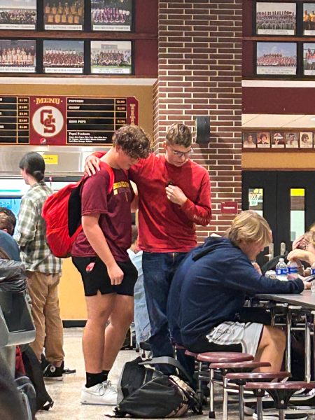 Sophomore Denver Clark takes time during lunch to pray with another student. Clark felt the Holy Spirit talking to him, and he took time to preach the Gospel to those willing to listen.