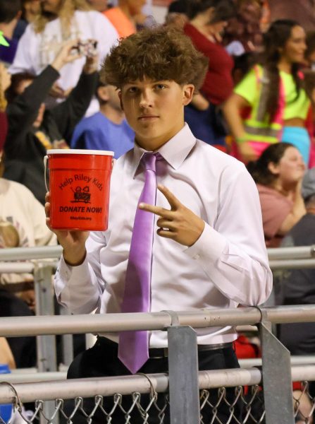 Homecoming Prince nominee, freshman Atlee Boling, does his part to collect donations for Riley Hospital for Children during the Miracle Minute at halftime of the varsity football game against South Warren. More than $1,000 was collected for the hospital by the entire Homecoming Court.