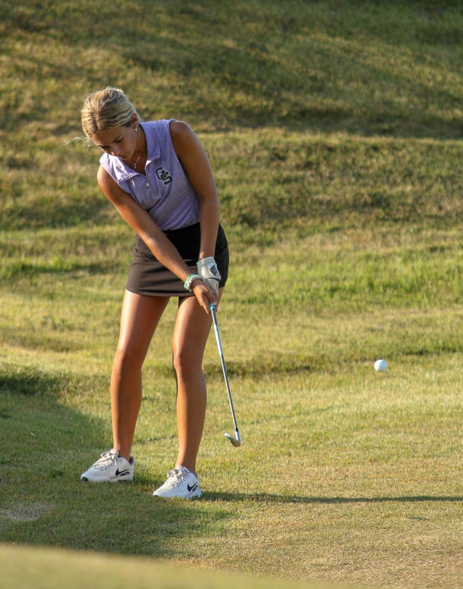 Senior Haley Hughes chips onto the green at the September 10 match against North Posey and Central High School. Hughes captured her second PAC Championship on September 7.