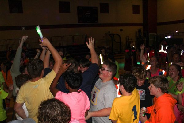 Students at this year's Fall Homecoming Dance crowd around the DJ and have a good time. While the dance is open to all Titans, more underclassmen attend than upperclassmen.