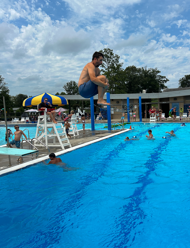 Practicing the perfect cannonball form, this is two jumps into the pool before history teacher and girls basketball coach Kyle Brasher hurt himself. Brasher missed the start of the school year due to surgery.