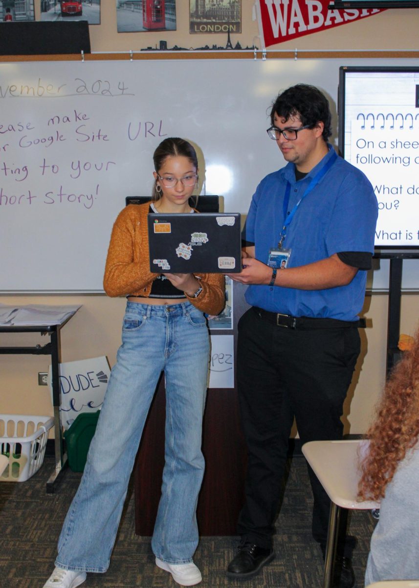 Freshman Tenley Beloat receives help on her Google Sites project from Felipe Lopez, a student teacher in the English department from Indiana State University. Lopez is teaching Jared Grigsby's English 9 classes until November 22.