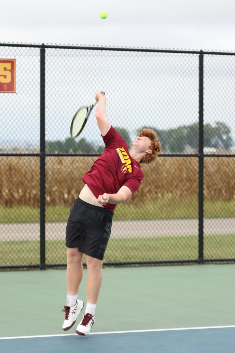 Sophomore Brayden Campbell smashes a serve in the September 23 match against Mater Dei. Campbell and his doubles partner, sophomore Carter DeBord, won their set in the Sectional 9 championship on October 3 at Princeton High School.