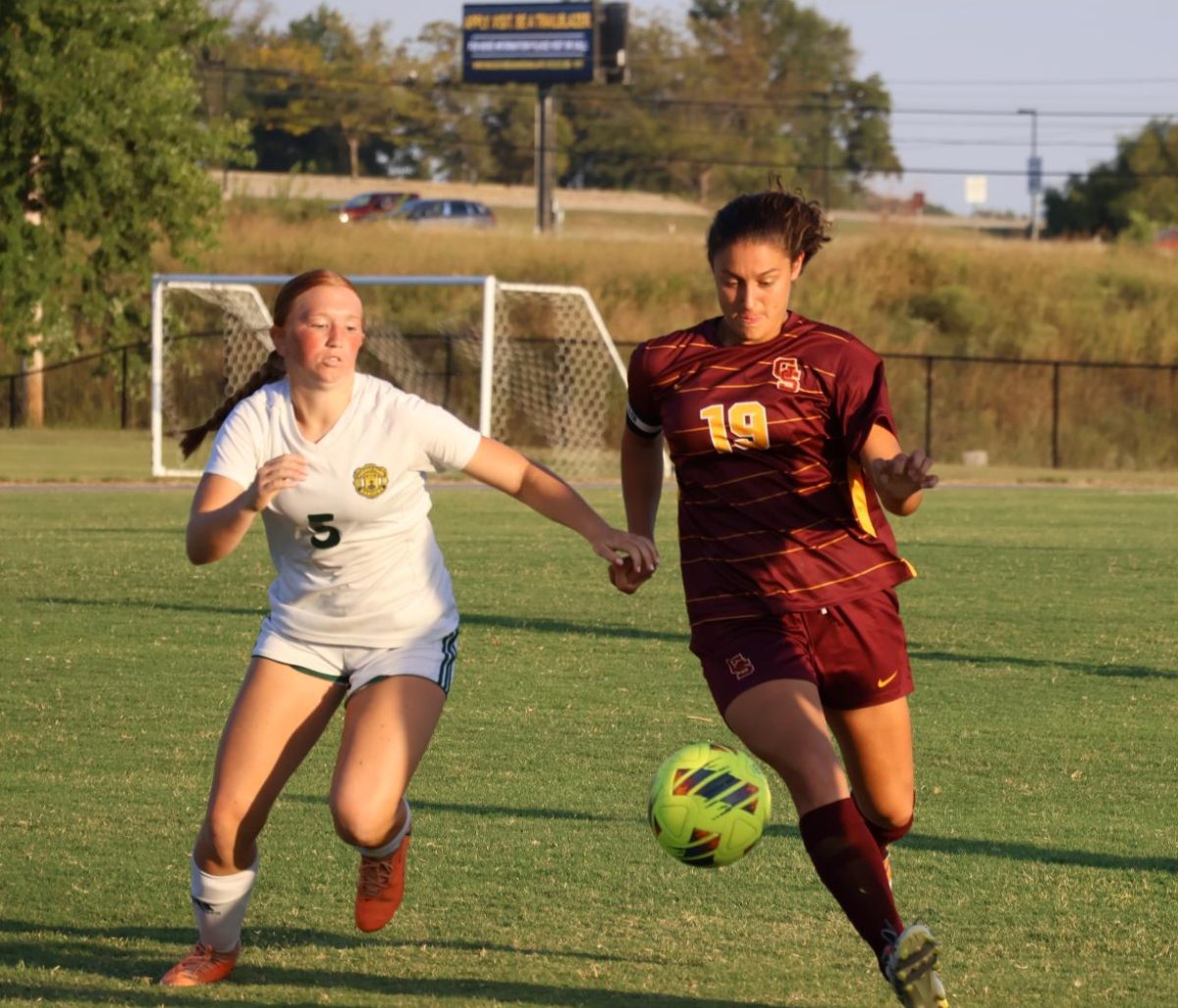 In the September 20 game against Forest Park, senior Alyssa Baehl works through the Lady Ranger's defence to set up for a shot on the goal.