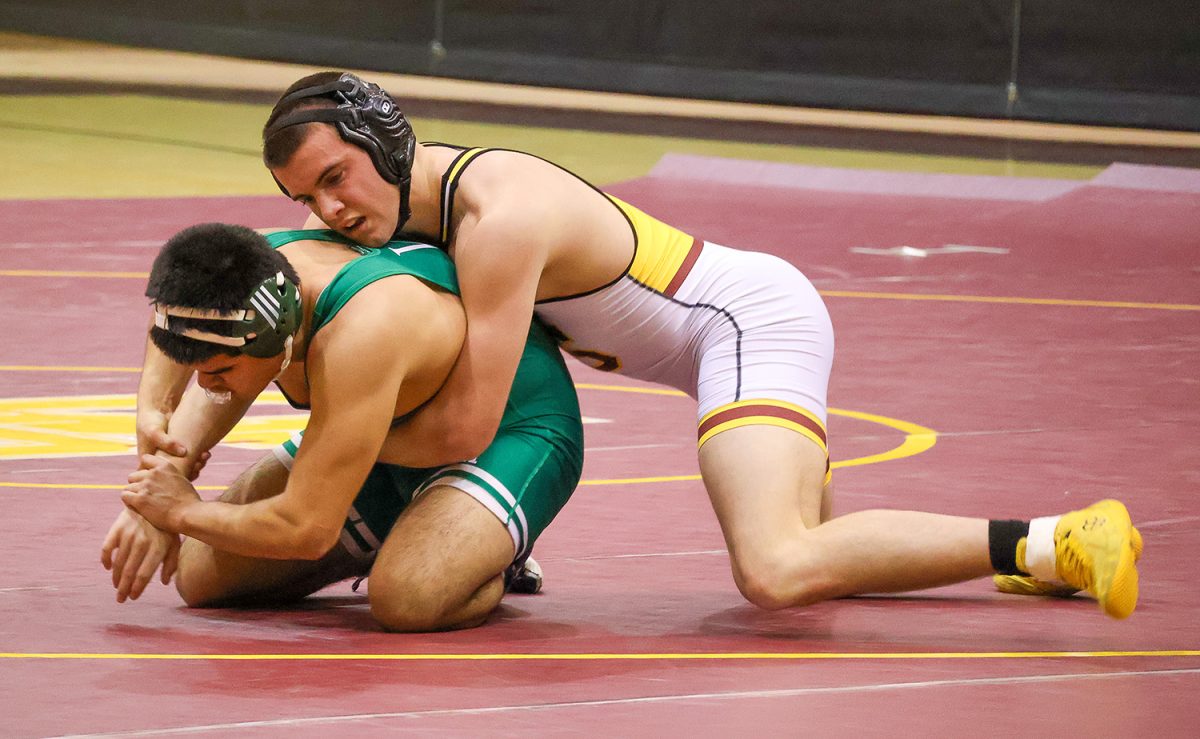 Freshman Jaxon Kiefer grapples with a Vincennes Lincoln wrestler on January 14, the Titans' only home meet for the season. Kiefer wrestled at 175 pounds.