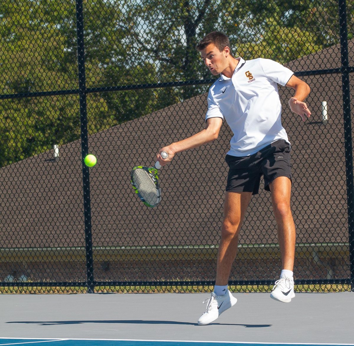 Senior Landon Schmitt returns a volley earlier in the season when the team traveled to Silver Creek for a two-day tournament.