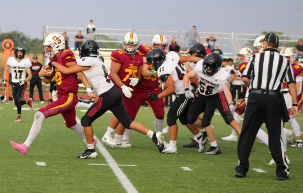 Junior quarterback Caden Rochleau breaks through the Raiders to move closer to the end zone.