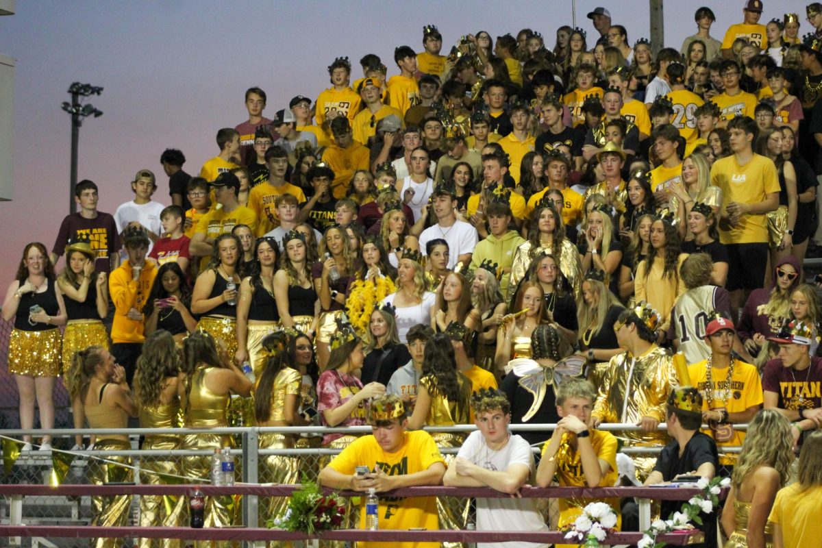 Students pack the Titan stands, bedecked in as much gold as possible, for the Homecoming game against Henderson County. Between the efforts of Student Council, the cheerleaders and Titan Up!, there has been an increase in school spirit.